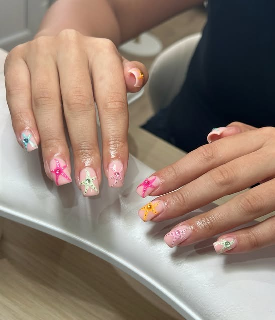 Long nails with pink tips and hand-painted starfish art